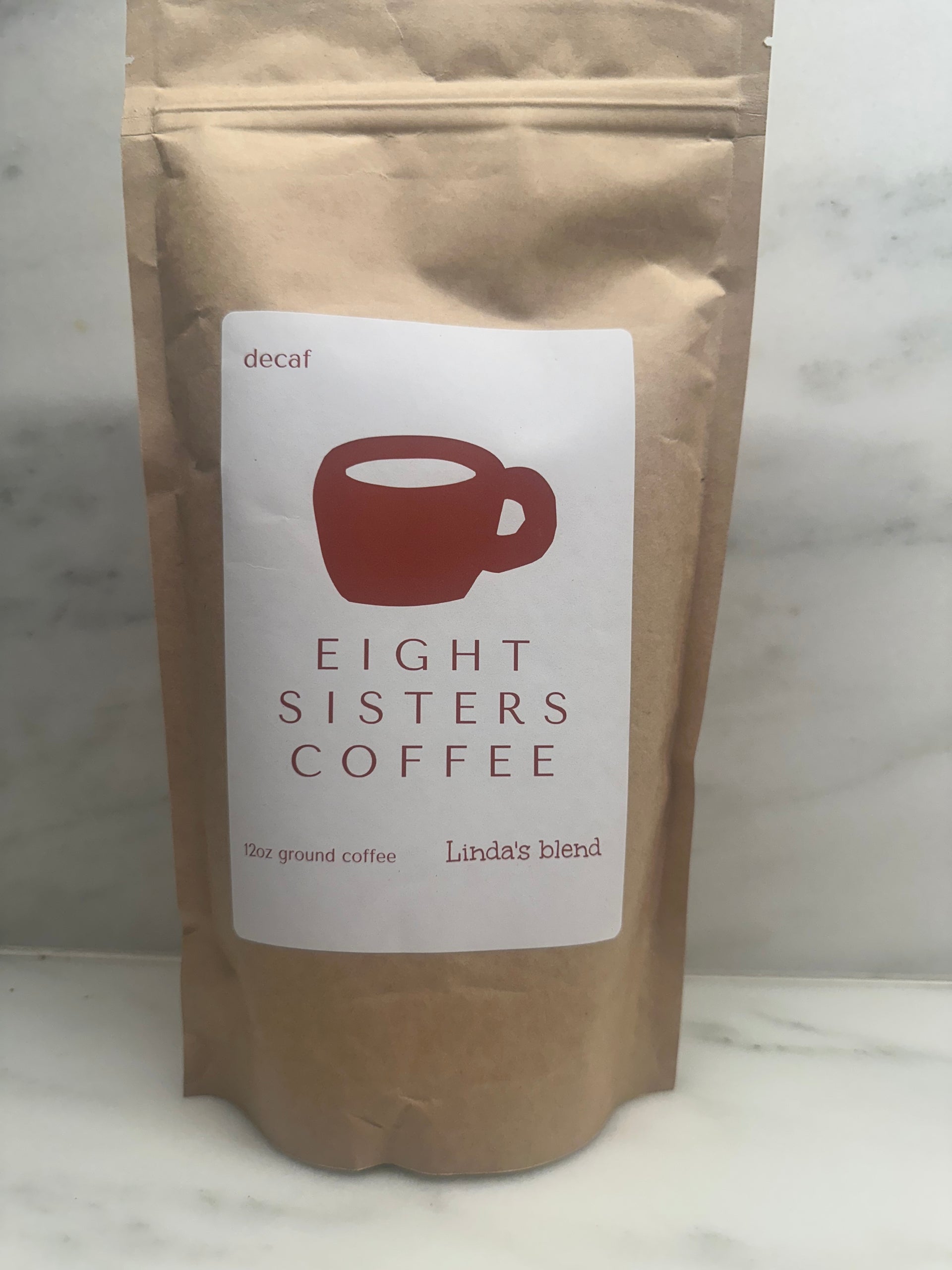 Eight Sisters Coffee 12oz Linda's Blend - Decaf Ground Coffee package on a marble surface