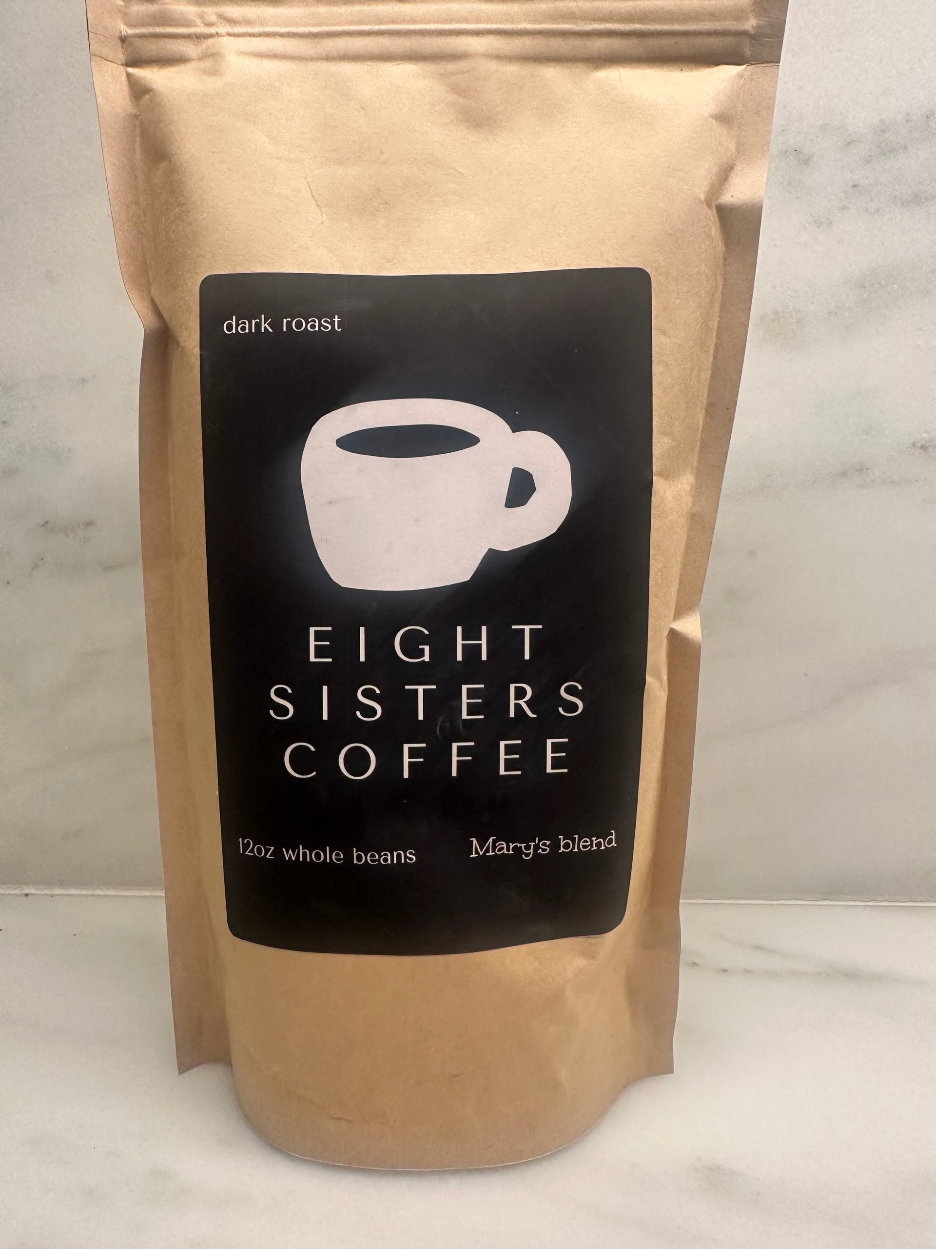 Eight Sisters Coffee 12oz Mary's Blend - Dark Roast Coffee Whole Beans in package on a marble surface