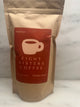 Eight Sisters Coffee 12oz Paula's Blend - Hazelnut ground coffee beans on a marble surface
